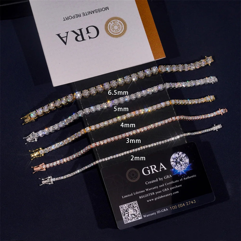 Five diamond tennis bracelets in different widths (2mm to 6.5mm) displayed on a clear stand, with a GIA certificate and a GIA logo card behind them on a dark background.