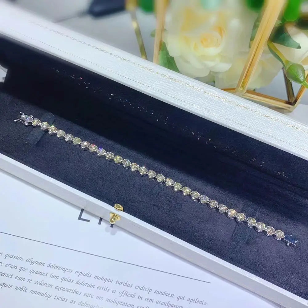 Silver bracelet with gemstones in a jewelry box with floral background
