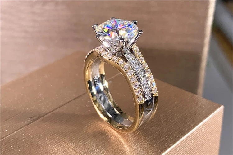 Gold and diamond ring on a wooden surface
