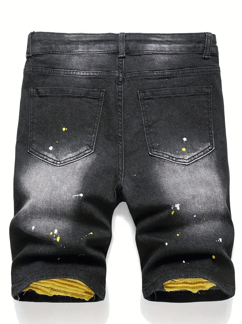 Black distressed jeans with yellow accents on a white background