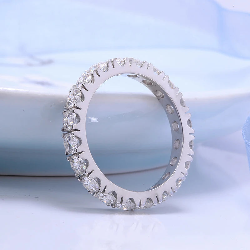 Silver ring with diamonds on a light blue background