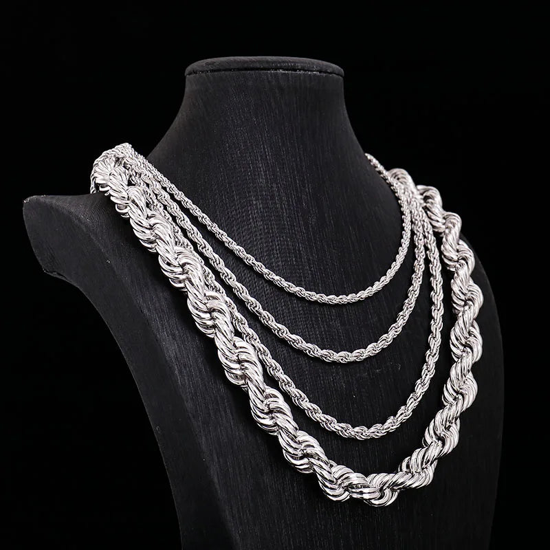 Silver rope chain necklace on a black mannequin bust against a black background
