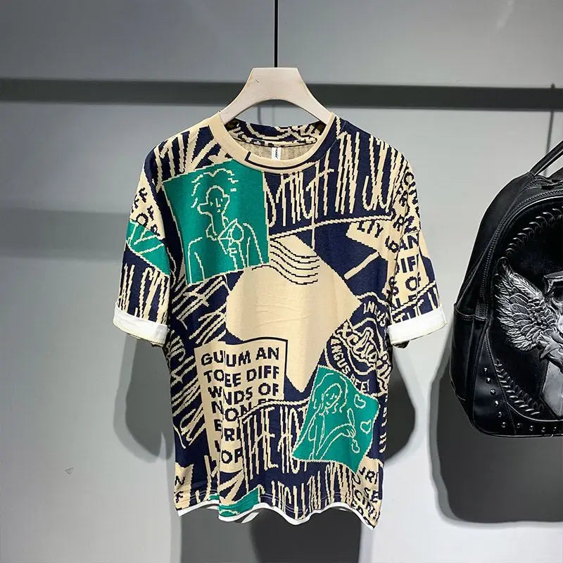 Colorful graphic t-shirt on a hanger with a black backpack in the background