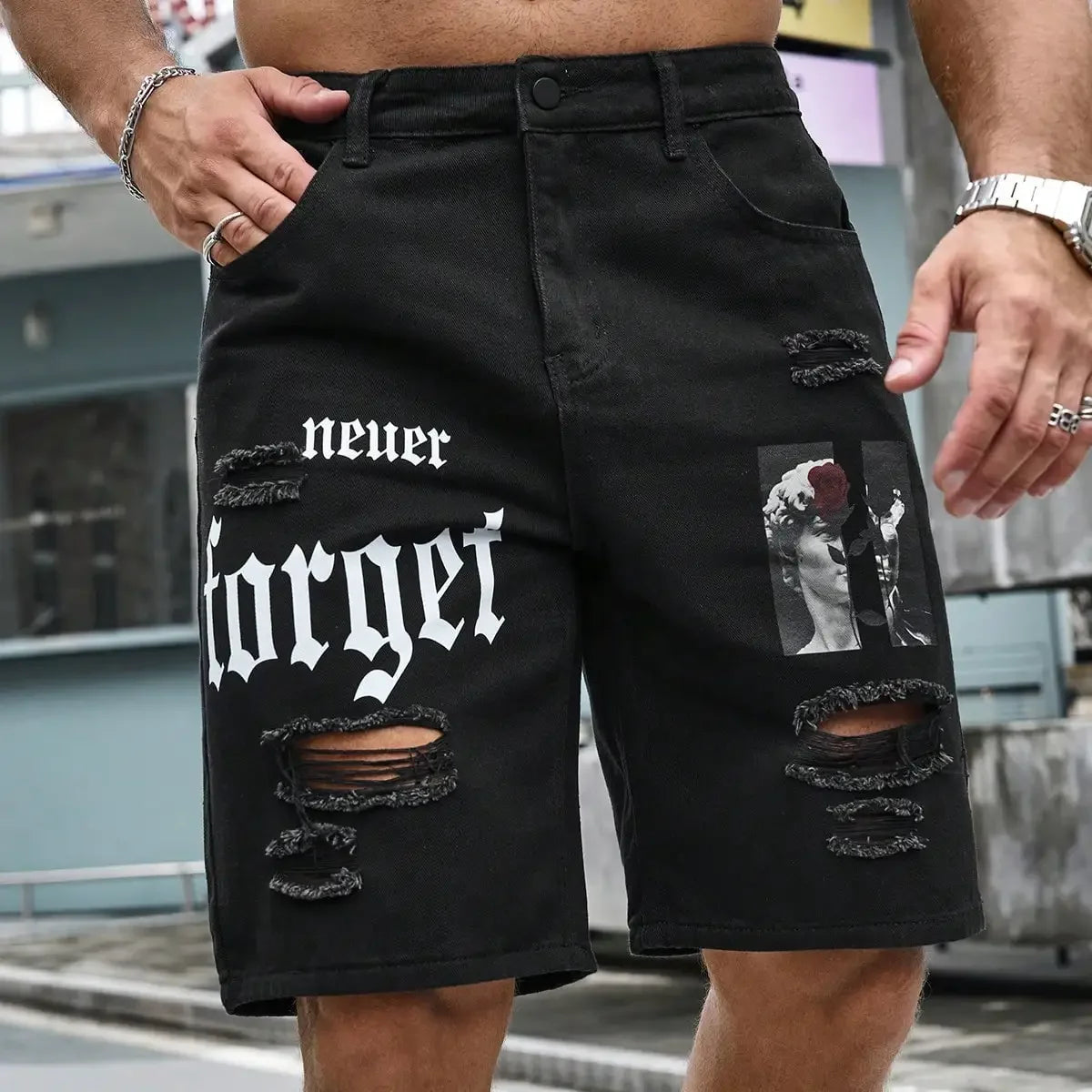 Black shorts with 'never forget' text and graphic design worn by a person outdoors.