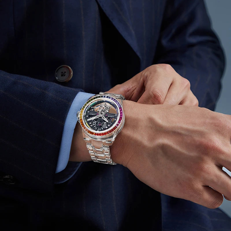 Person wearing a luxurious watch with a colorful bezel on a dark background