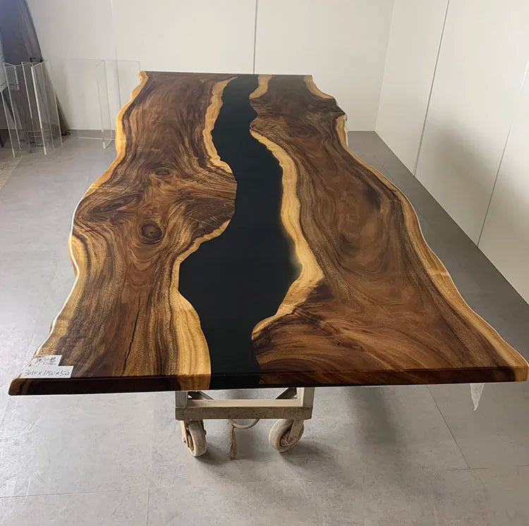 Wooden table with black resin inlay on a gray floor