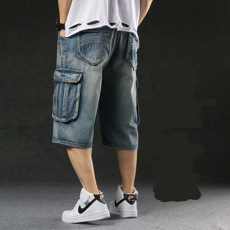 Person wearing blue cargo shorts and white sneakers on a dark background