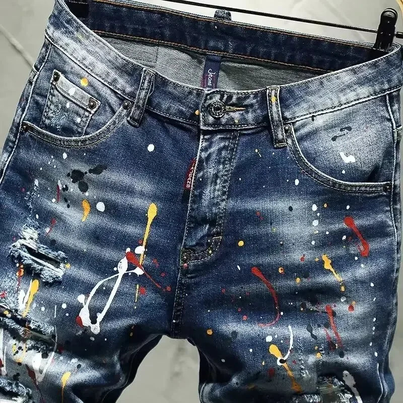 Blue jeans with paint splatter design on a hanger