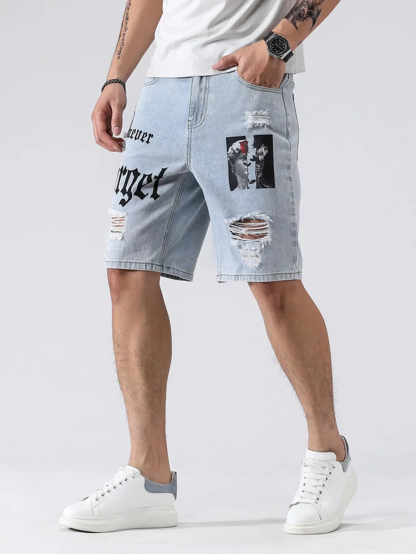Person wearing light blue denim shorts with graphic designs on a white background