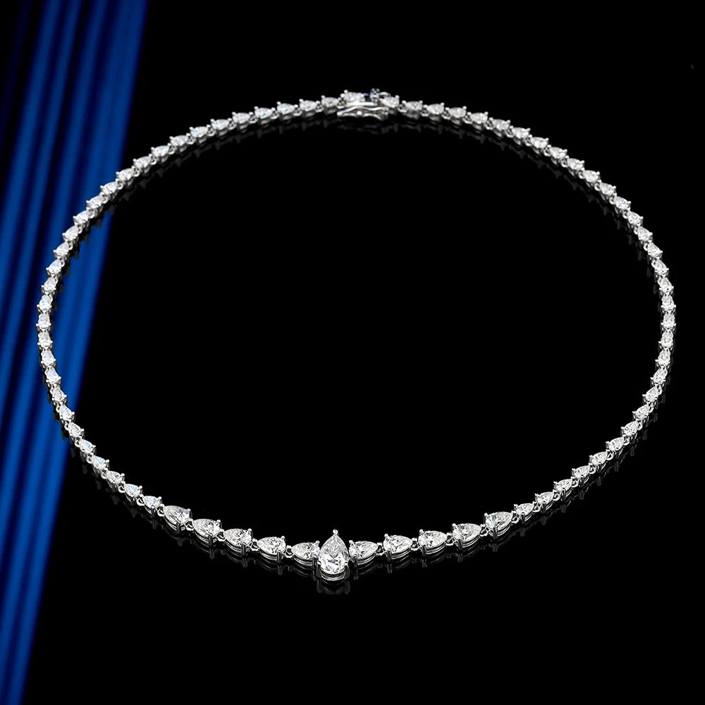 Diamond necklace on a black background with blue fabric