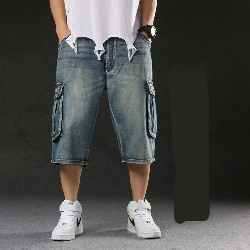 Person wearing blue cargo shorts and white sneakers on a dark background