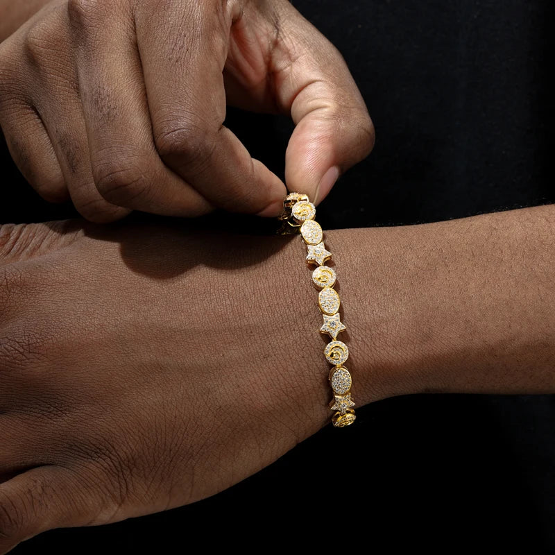 Gold bracelet being adjusted on a wrist against a dark background