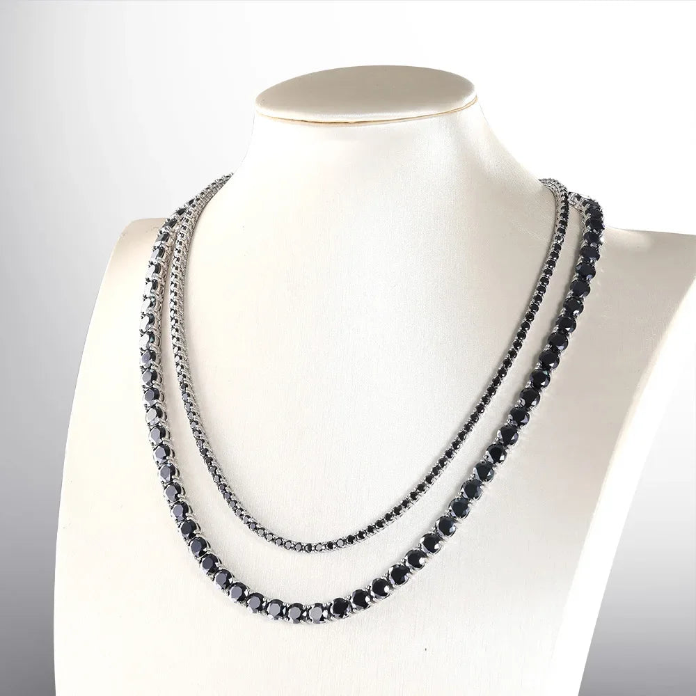 Black beaded necklace on a mannequin against a white background