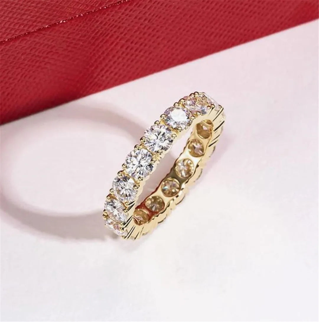 Gold ring with diamonds on a red and white background