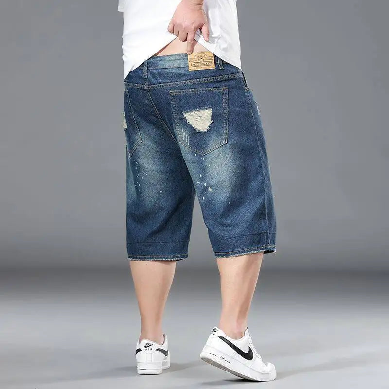 Person wearing blue denim shorts on a gray background