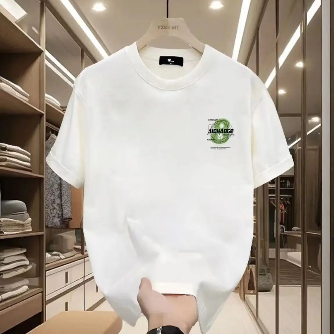 White t-shirt with a logo on a hanger in a clothing store.