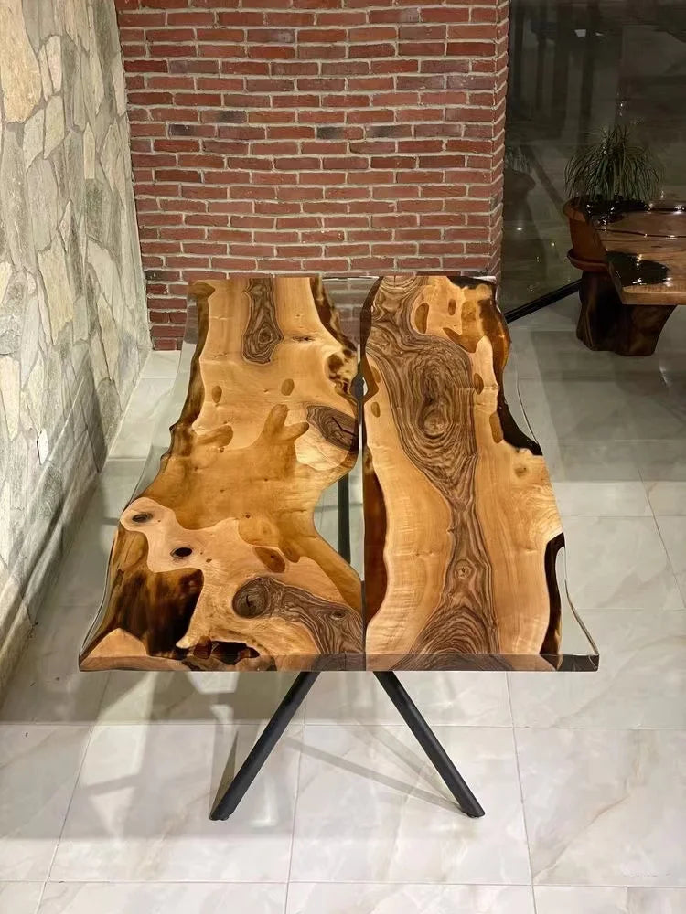 Wooden table with natural grain pattern in a room with stone walls and a brick column.