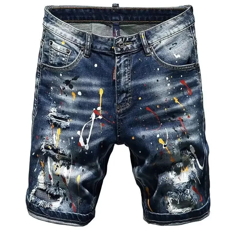 Blue denim shorts with colorful paint splatter design on a white background
