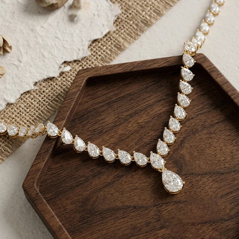 Diamond necklace on a wooden tray with a textured background