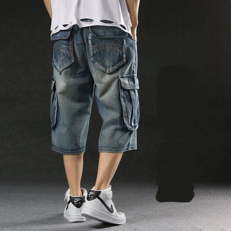 Person wearing blue cargo shorts and white sneakers on a dark background