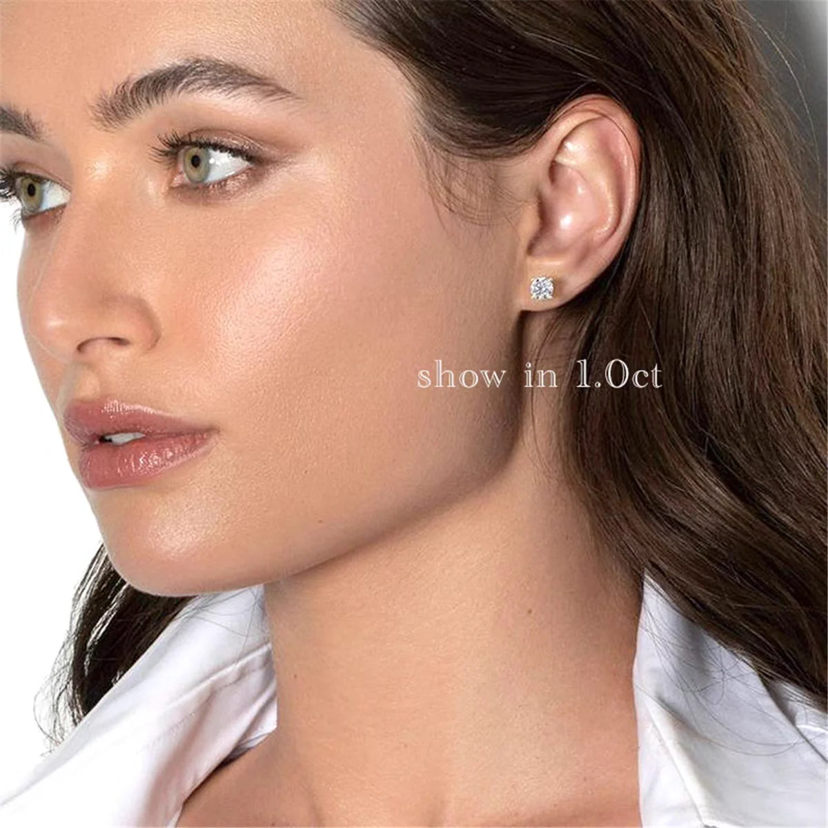 Close-up of a woman wearing a diamond earring with text 'show in 1. Oct' on a light background.