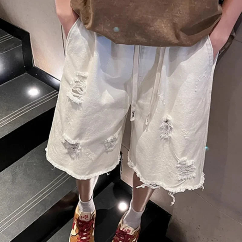 Person wearing white distressed shorts and colorful sneakers on a staircase.