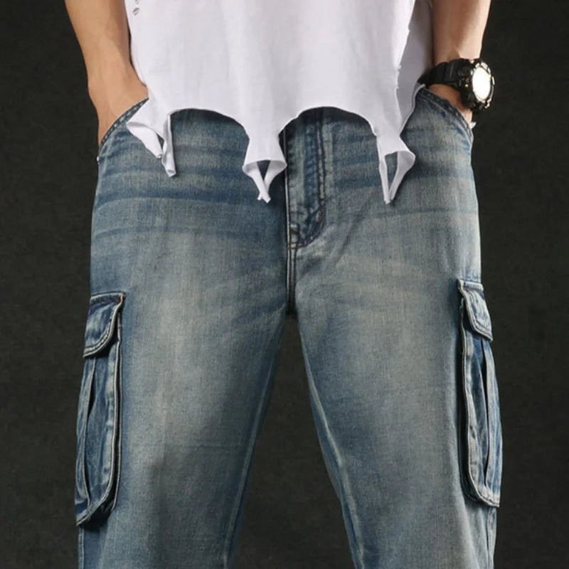 Person wearing blue cargo jeans with a plain background