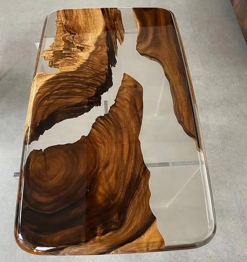 Wooden table with a clear resin overlay on a gray surface