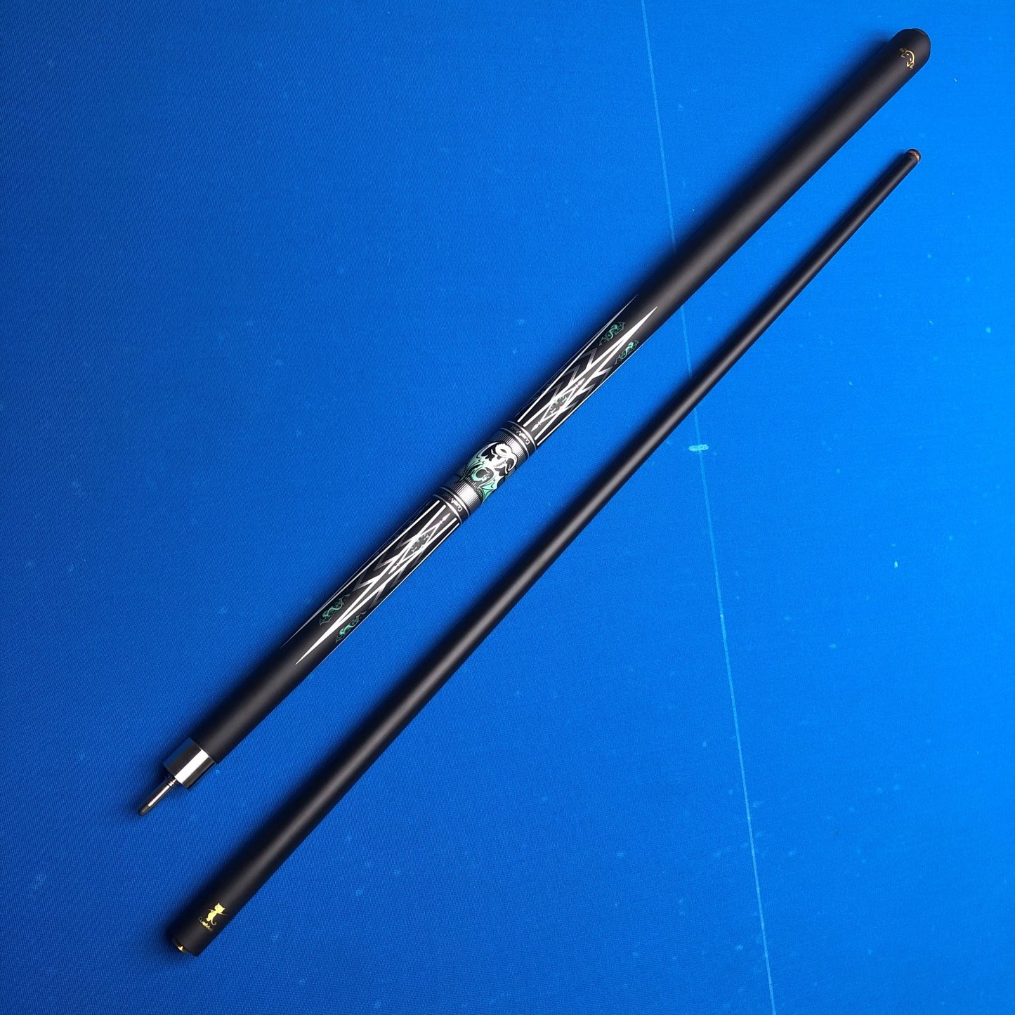 Two black sticks with decorative elements on a blue background