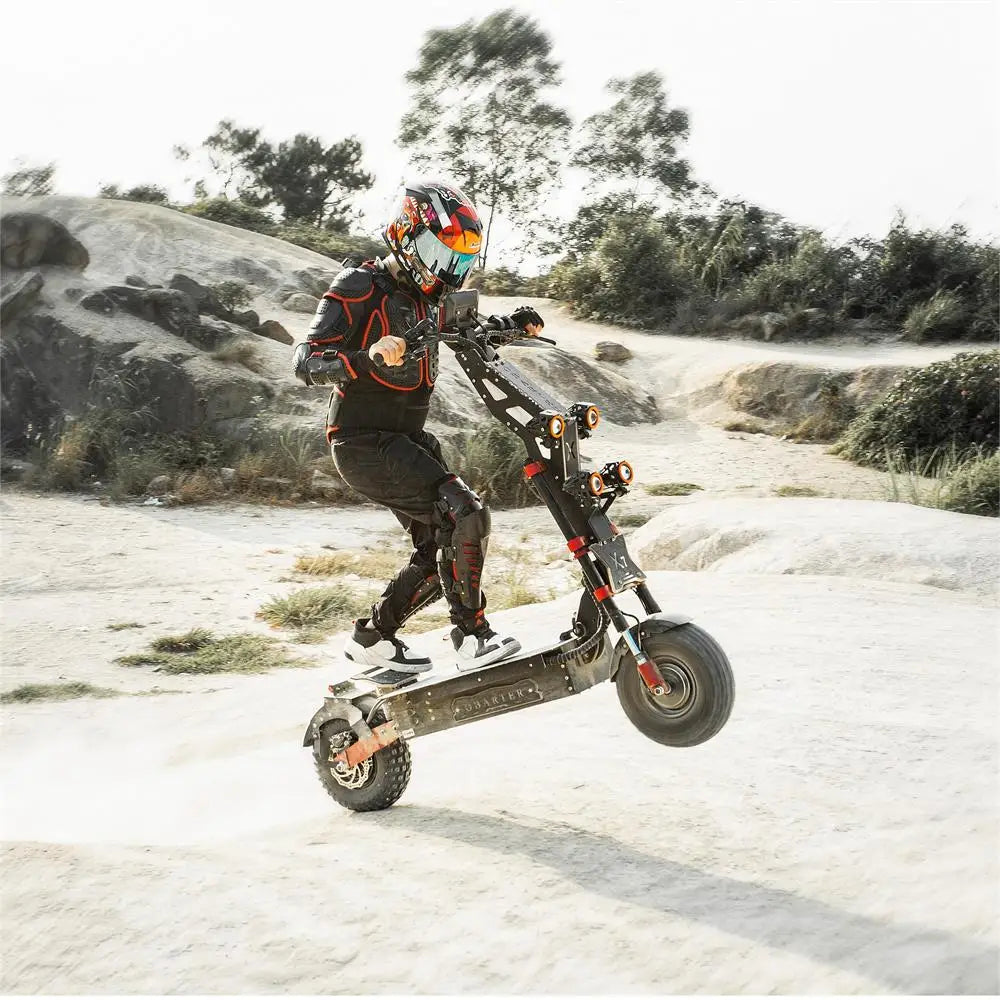 Person riding a motorized scooter on a rocky, outdoor path with trees in the background.
