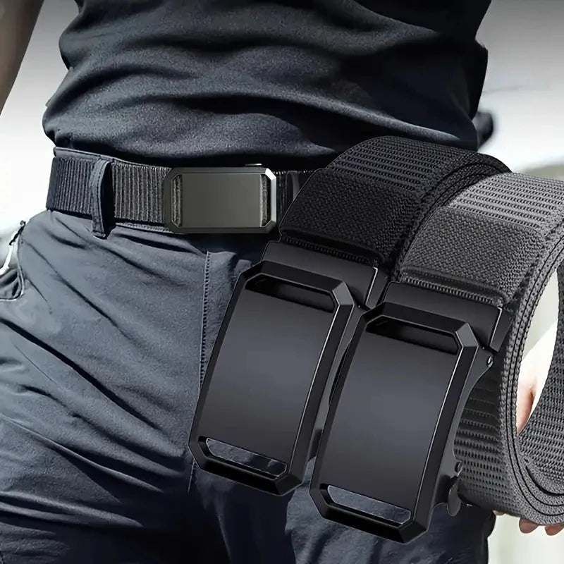 Black tactical belt with a large buckle held by a person wearing dark pants.