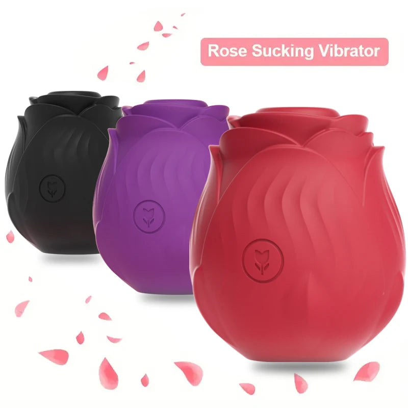 Three rose-shaped vibrators in black, purple, and red with pink flower petals on a white background.
