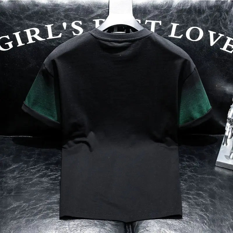 Black t-shirt with green sleeves on a hanger against a dark background with text.