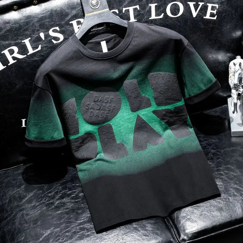 Green and black t-shirt with text on a dark surface