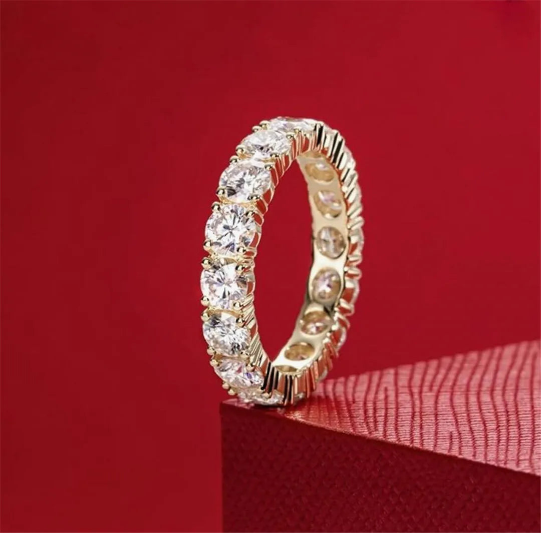 Gold ring with diamonds on a red background