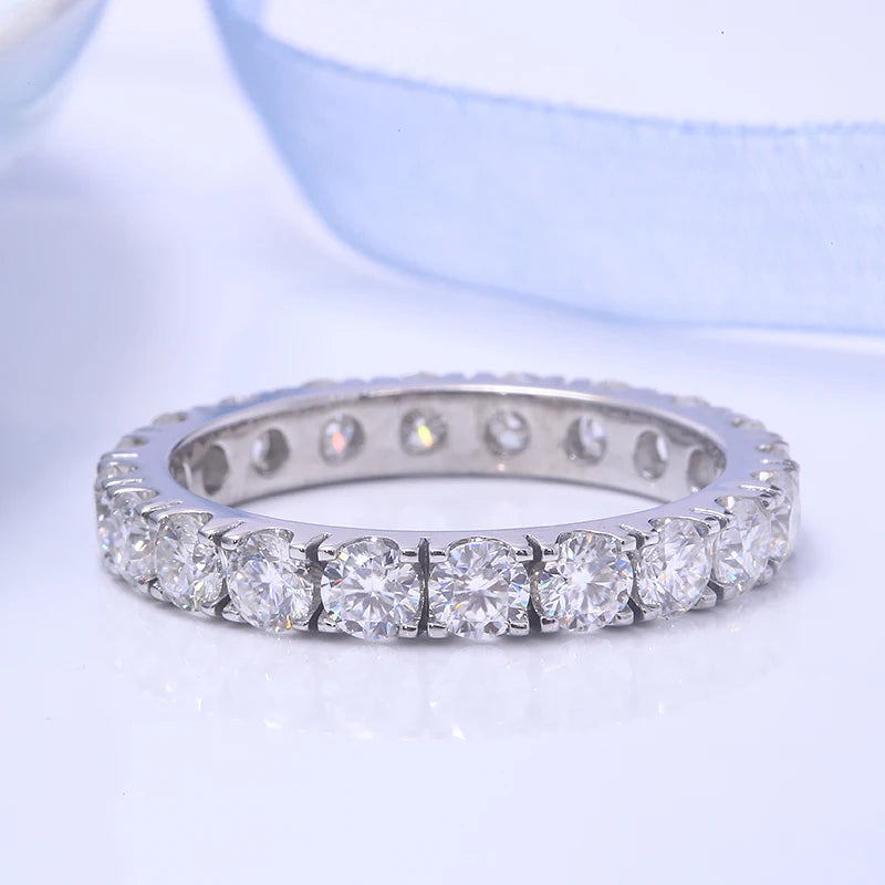 Silver ring with diamonds on a light blue background