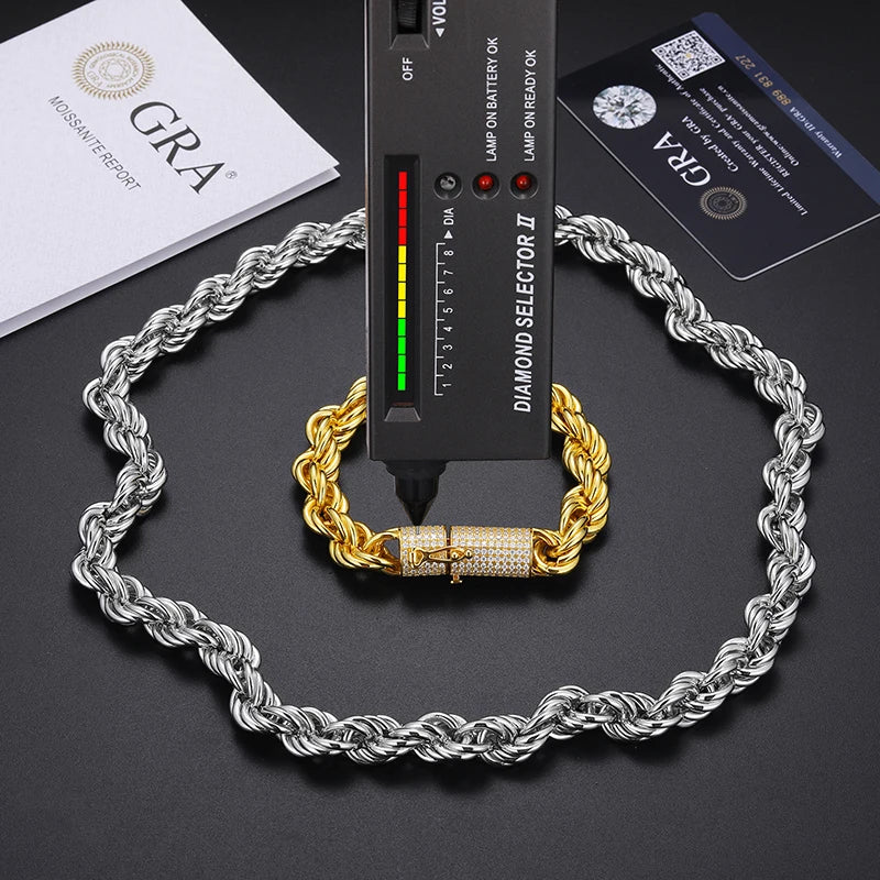Two chains, one silver and one gold, with a diamond selector tool on a dark surface.
