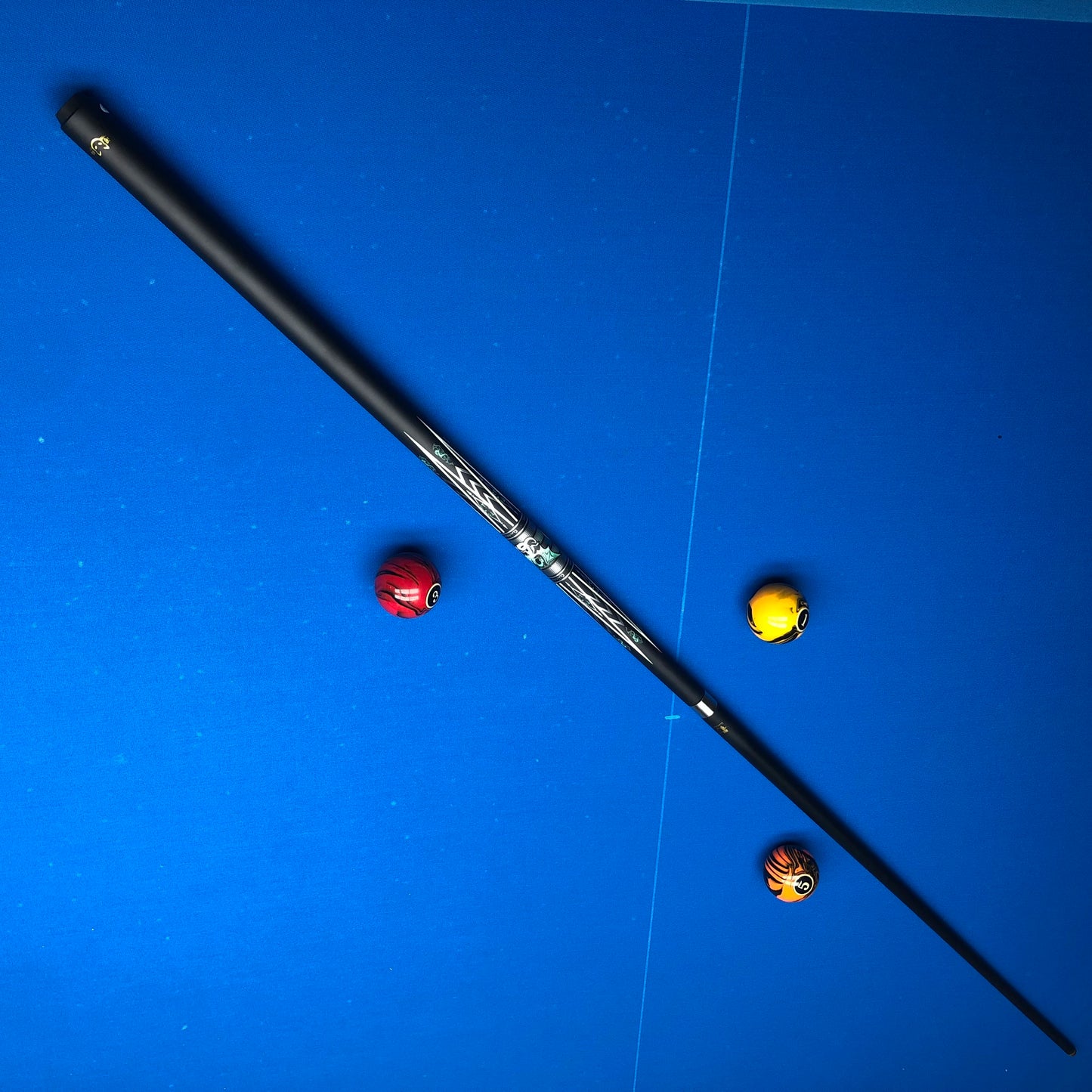 Fishing rod with three colorful beads on a blue surface