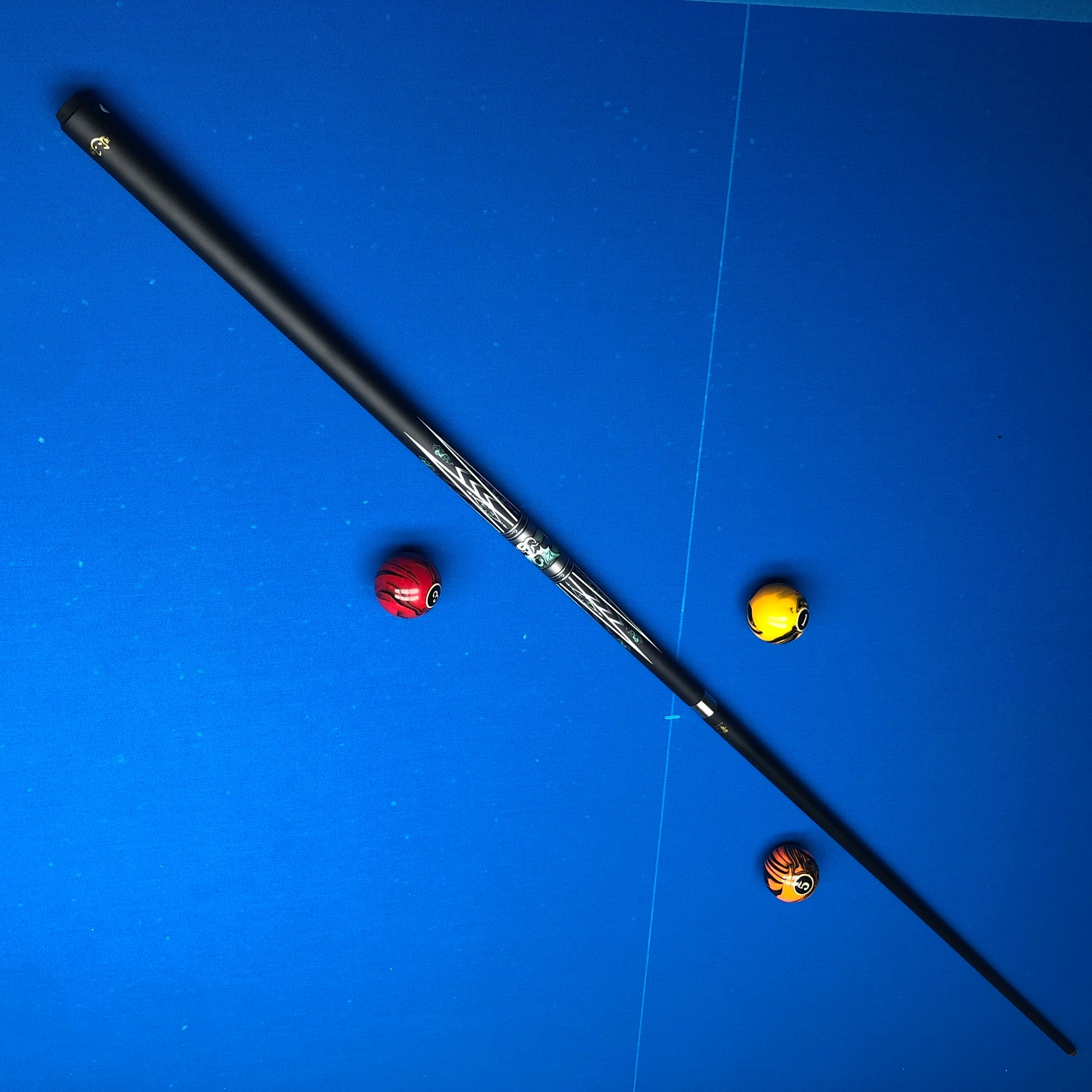 Fishing rod with three colorful beads on a blue surface
