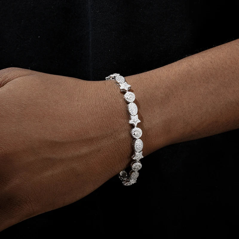Silver bracelet on a wrist against a black background