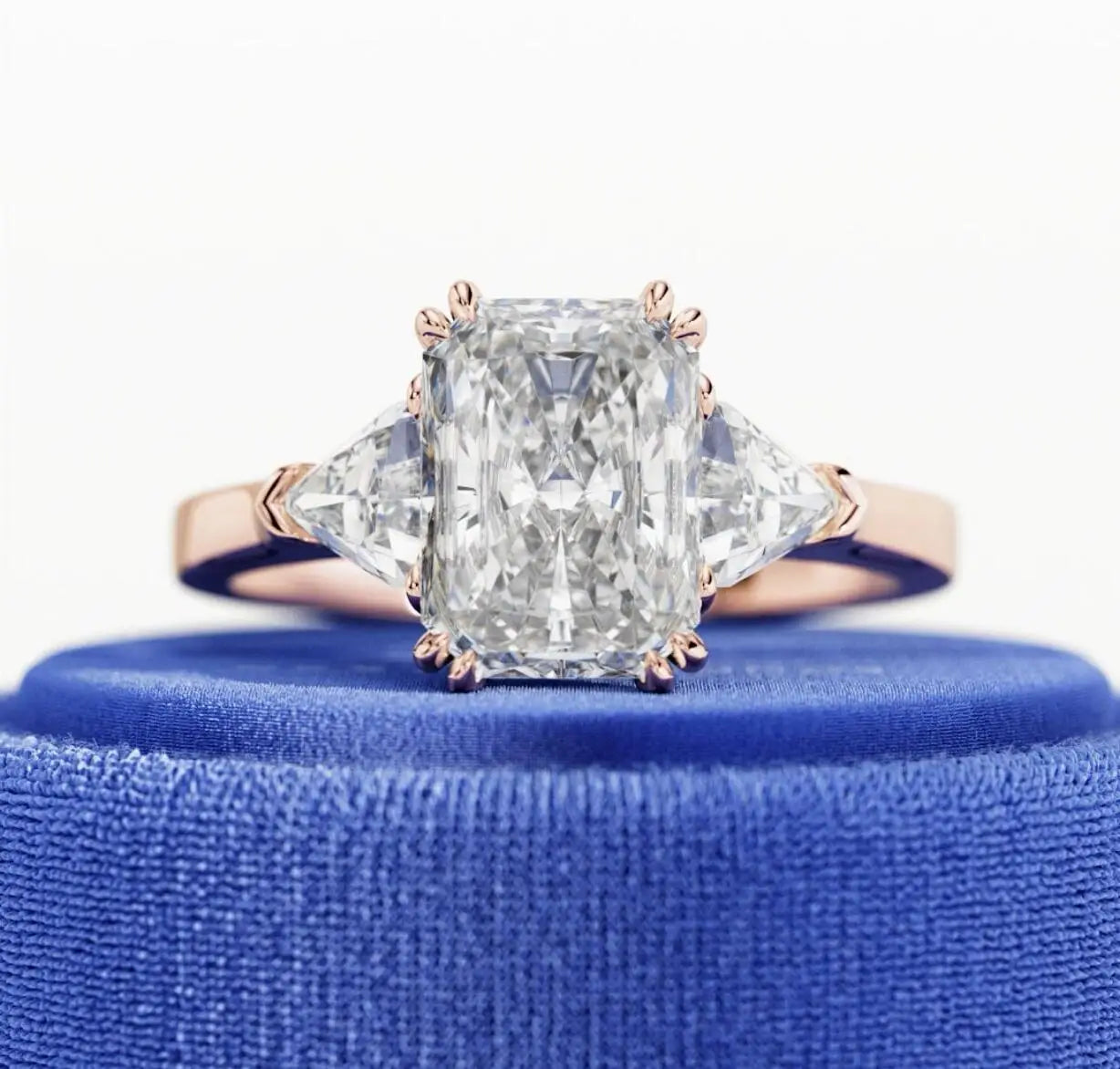 Diamond ring with a blue cushion on a white background