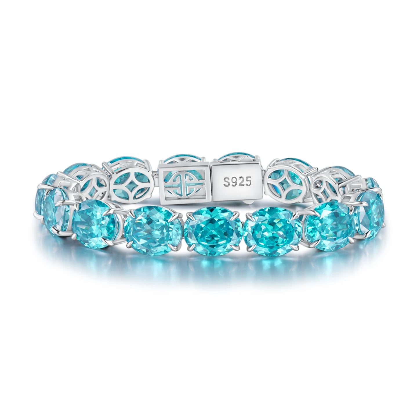A silver tennis bracelet featuring round-cut light blue gemstones and geometric openwork links, with a clasp stamped 'S925', shown on a white background with a soft reflection.