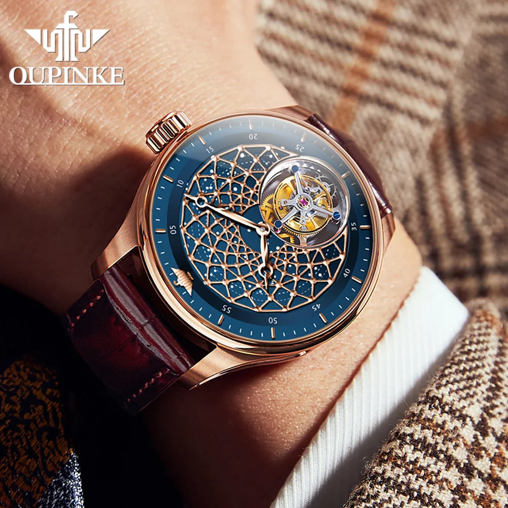 A wristwatch with a rose gold case, blue dial, and brown leather strap, shown worn on a person's wrist against a brown plaid background. The brand name 'OUPINKE' is visible in the top left corner.