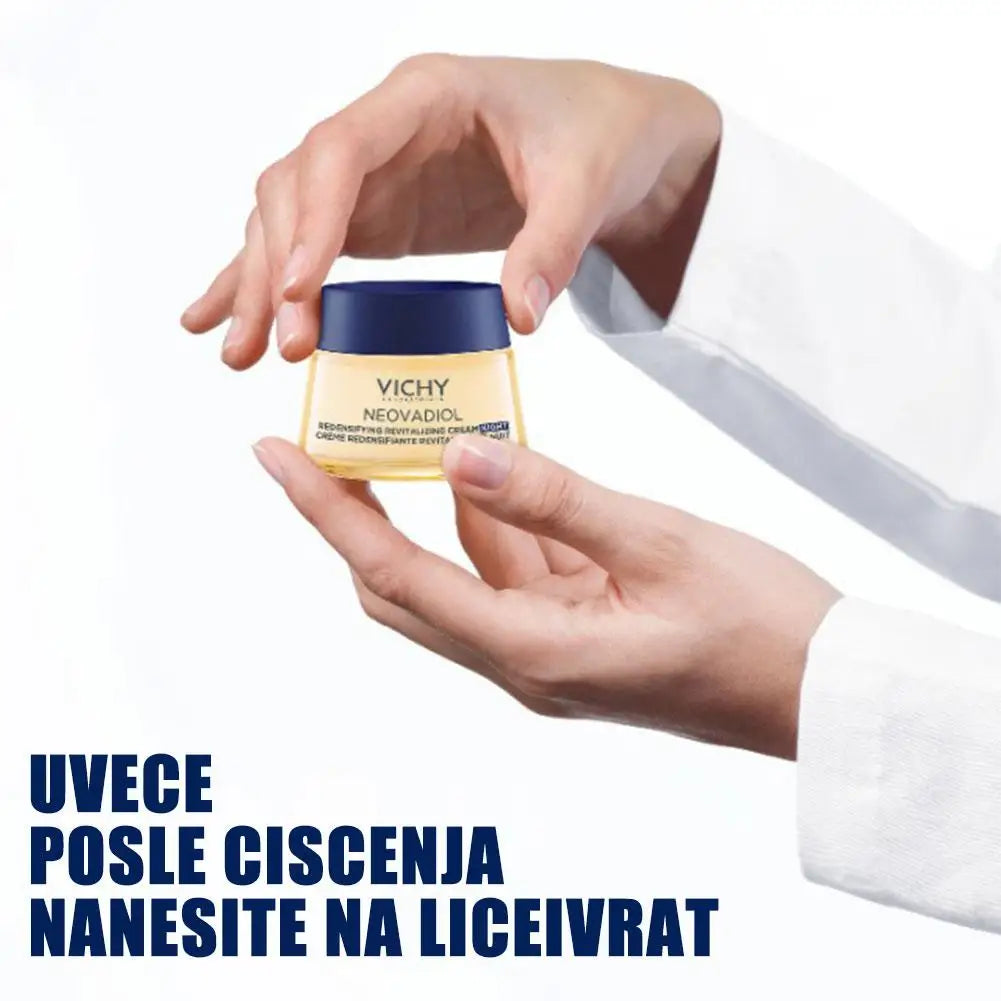 Vichy Neovadiol cream jar held by a hand with a white background