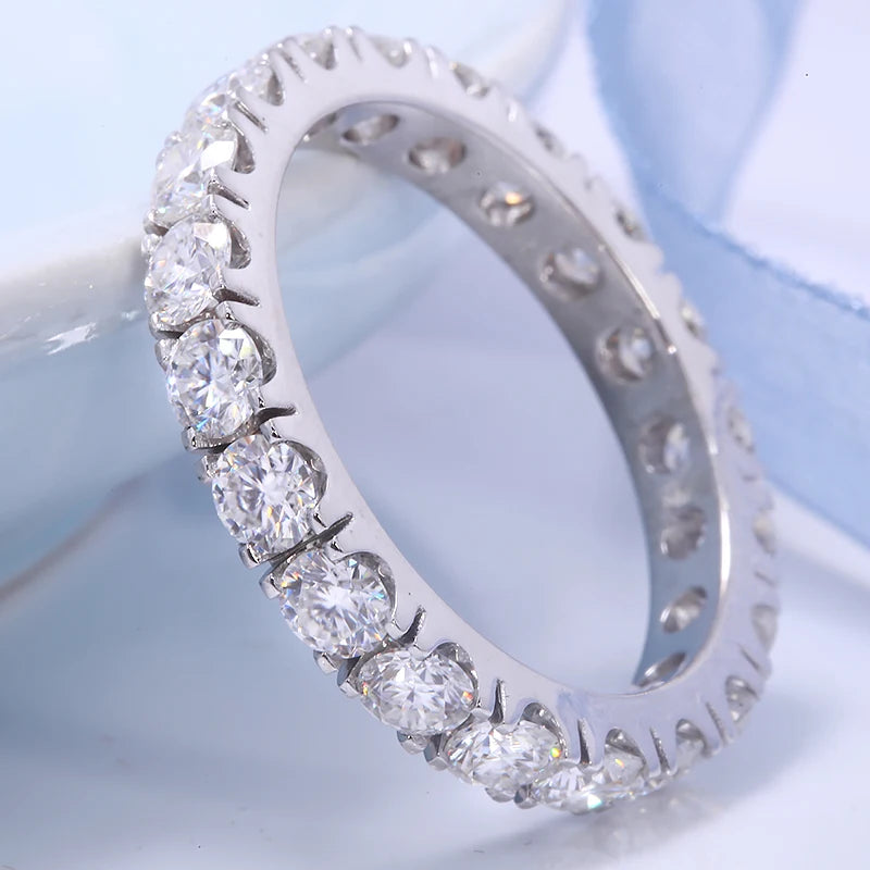 Silver ring with diamonds on a light blue background