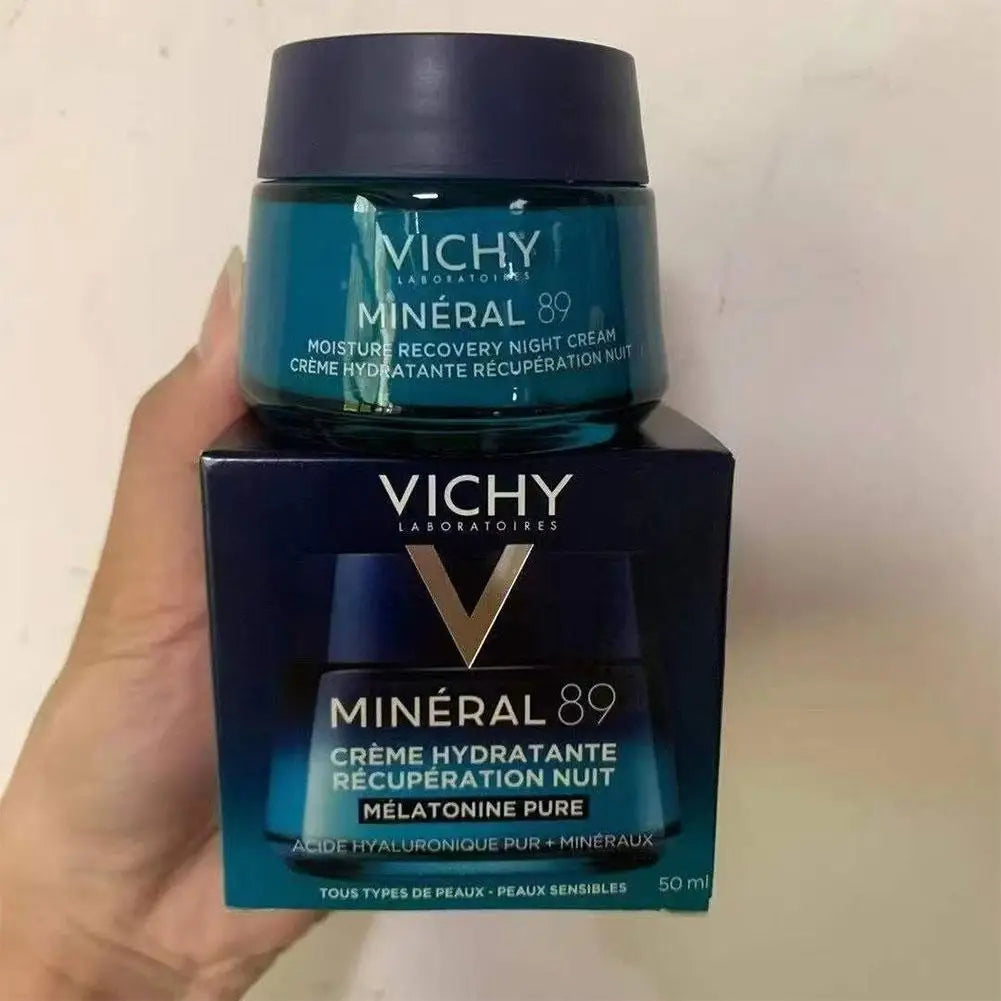 Vichy Mineral 89 night cream jar and packaging held by a hand against a plain background