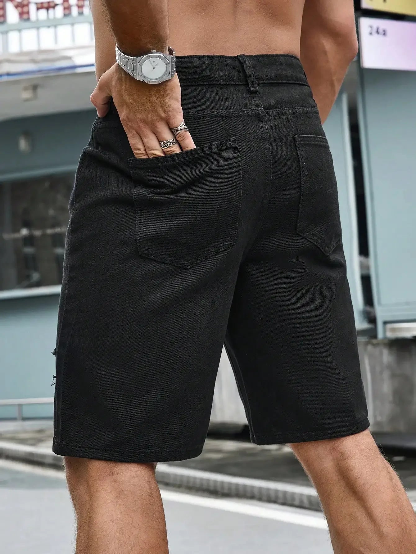 Person wearing black shorts with a blurred background