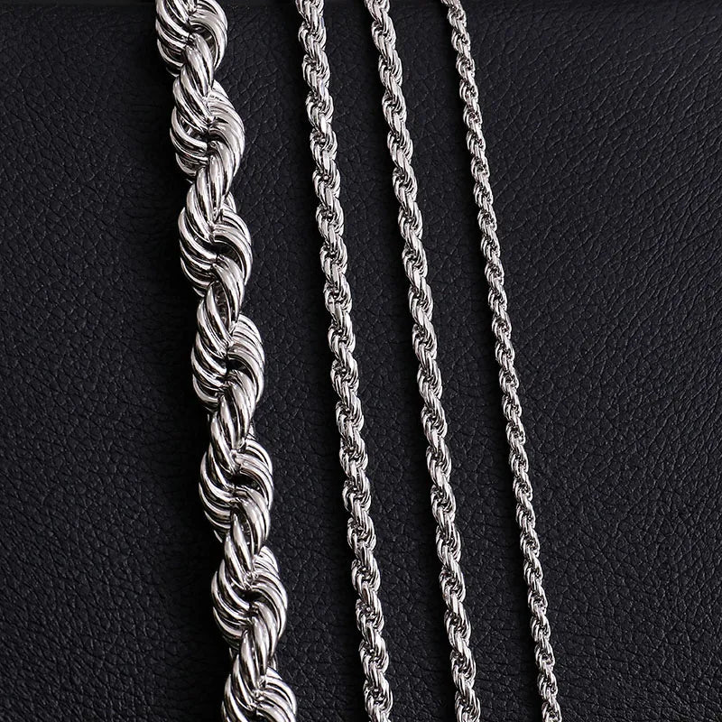Three silver rope chains on a black textured background