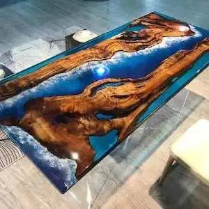 Table with a unique design featuring wood and blue resin on a glass surface.