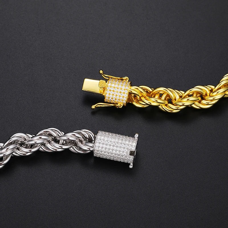 Gold and silver chain bracelets with diamond-studded clasp on a black background